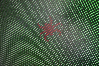 ensemble de chiffre vert 0 ou 1 dont certain sont rouge pour dessiné une silhouette d'insecte